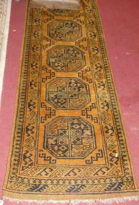 Lot 1157 - A Persian woollen mustard ground Bokhara hall...