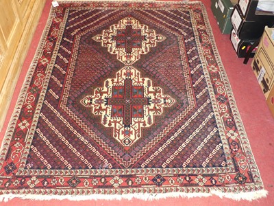 Lot 1165 - A Persian woollen blue ground Shiraz rug, 174...