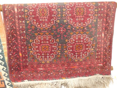 Lot 1166 - A Persian woollen red ground Bokhara rug, 130...