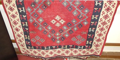 Lot 1168 - A Turkish red ground Kelim rug, with stylised...