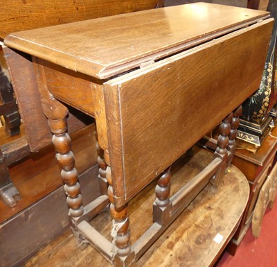 Lot 1212 - An antique joined oak bobbin turned dropflap...