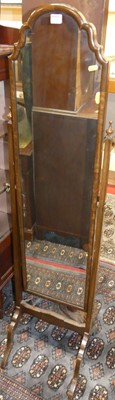 Lot 1230 - A 1930s walnut shaped arch topped cheval mirror