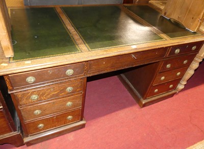 Lot 1237 - A late Victorian oak and gilt tooled green...