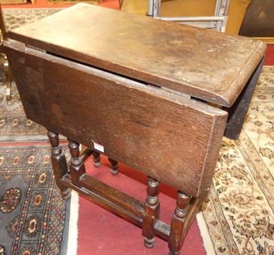 Lot 1260 - An antique joined oak dropflap gateleg...