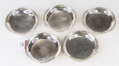 Lot 241 - A set of five silver coasters each with engine...