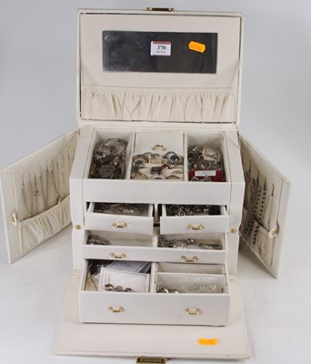 Lot 370 - A cream simulated leather clad jewellery box,...