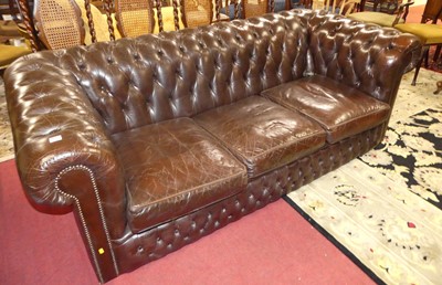 Lot 1421 - A chocolate brown leather buttoned upholstered...