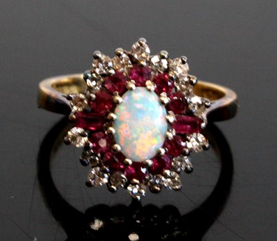 Lot 1282 - An 18ct yellow and white gold opal, ruby and...