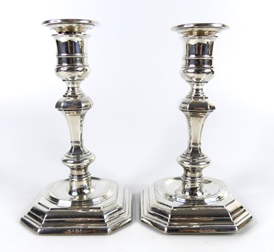Lot 1191 - A pair of Edwardian silver table candlesticks,...