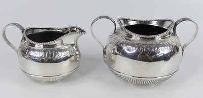 Lot 1180 - A Victorian silver sugar and cream duo, each...
