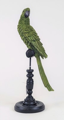 Lot 11 - A painted resin figure of a parrot upon a...