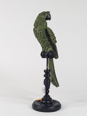 Lot 11 - A painted resin figure of a parrot upon a...