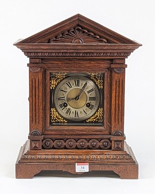Lot 34 - An early 20th century oak cased mantel clock...
