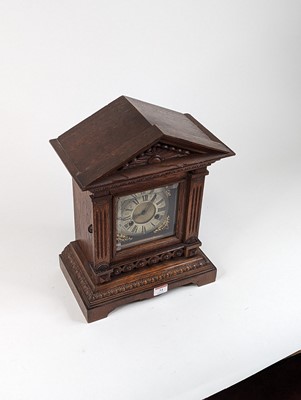 Lot 34 - An early 20th century oak cased mantel clock...