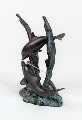 Lot 39 - A verdigris metal figure group of two dolphins,...