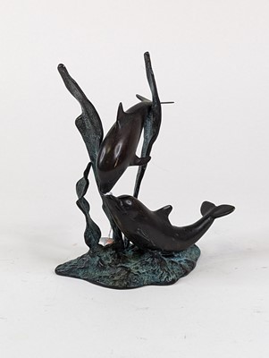 Lot 39 - A verdigris metal figure group of two dolphins,...