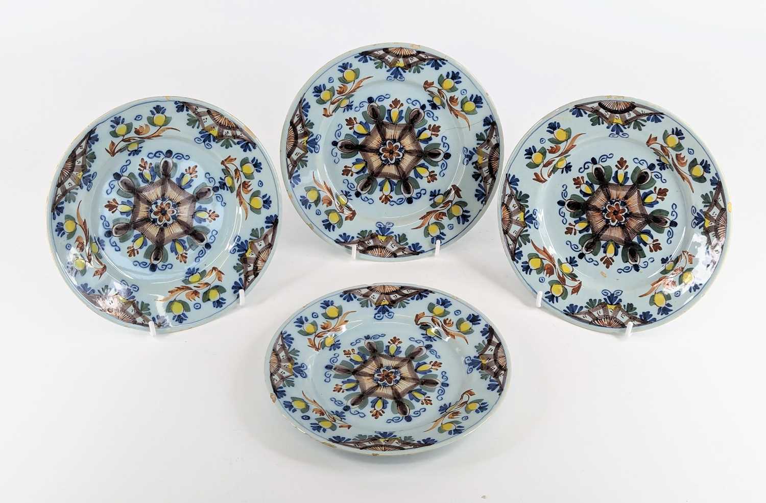 Lot 1101 - A set of four Lambeth polychrome delftware...