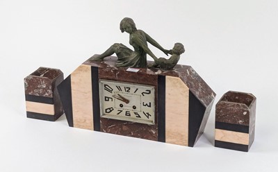 Lot 122 - An Art Deco rouge marble clock garniture, the...