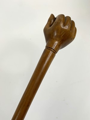 Lot 151 - A carved hard wood walking stick, the handle...