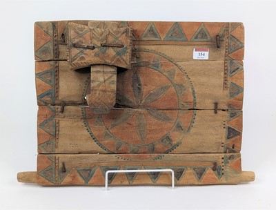 Lot 154 - An East African carved wood granary door and...