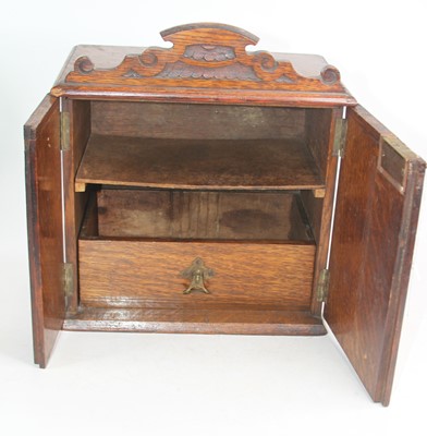 Lot 177 - An early 20th century oak tabletop smoker's...