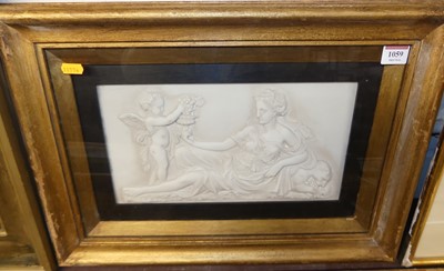 Lot 1059 - *A framed composition relief plaque depicting...