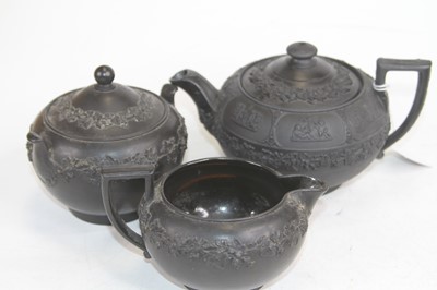 Lot 230 - A Wedgwood black basalt three-piece tea set,...