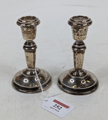 Lot 252 - A pair of silver dwarf table candlesticks, on...