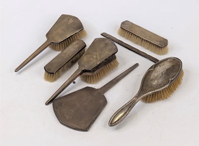 Lot 323 - An Art Deco silver clad dressing table brush...