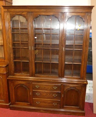 Lot 1164 - A contempoary oak bookcase, with three glazed...