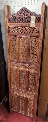 Lot 1169 - *A contemporary Indonesian relief carved and...