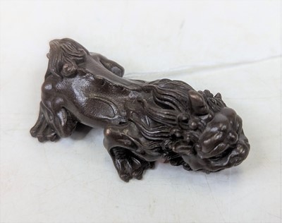 Lot 412 - A bronzed metal figure of a shishi, length 7cm