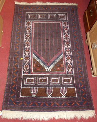 Lot 1200 - A Persian woollen prayer rug, the central...