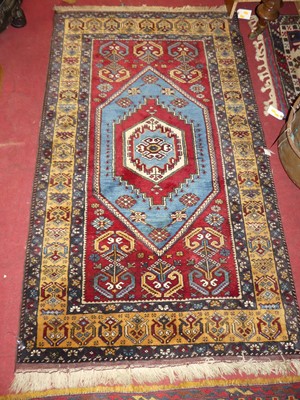 Lot 1203 - *A Persian woollen red and blue ground Oushak...