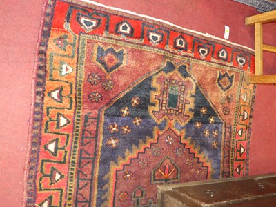 Lot 1208 - A Kurdish woollen blue and red ground rug,...