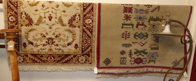 Lot 1211 - A Persian style cream and red ground woollen...