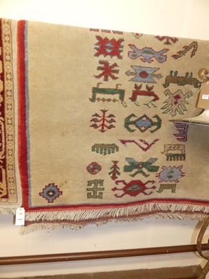 Lot 1211 - A Persian style cream and red ground woollen...