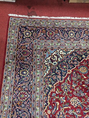 Lot 1213 - A large Persian blue, red and cream ground...