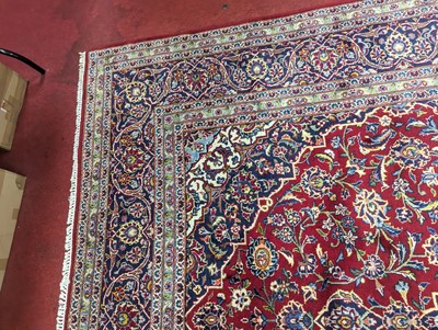 Lot 1213 - A large Persian blue, red and cream ground...