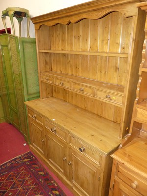 Lot 1226 - A rustic stained pine kitchen dresser, having...