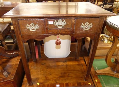 Lot 1241 - A George III oak three drawer lowboy, raised...