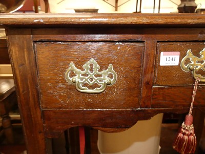 Lot 1241 - A George III oak three drawer lowboy, raised...
