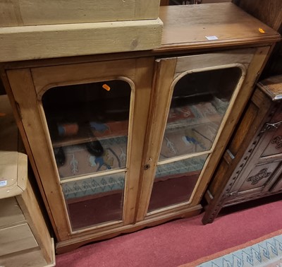 Lot 1266 - A rustic pine low double door glazed bookcase,...