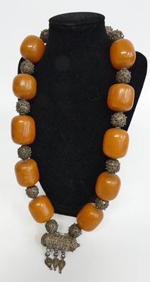 Lot 358 - An African faux amber and filigree worked...