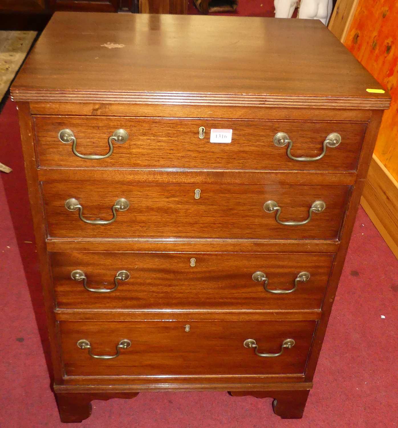 Lot 1316 - A small mahogany chest of four long graduated...