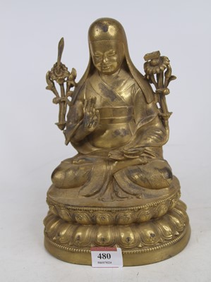 Lot 480 - A Chinese gilt metal figure of a seated deity...