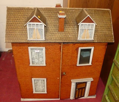 Lot 1372 - A vintage three-storey doll's house, having a...