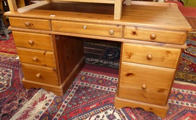 Lot 1382 - A modern pine round cornered kneehole desk,...
