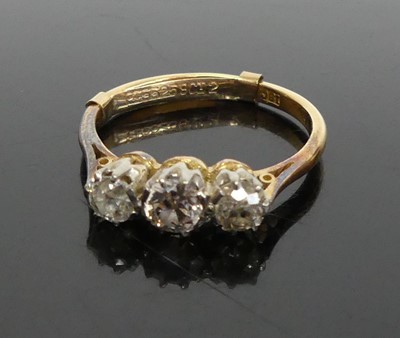 Lot 385 - An 18ct gold  diamond three stone ring...