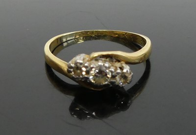 Lot 386 - An 18ct gold diamond three stone ring, the...